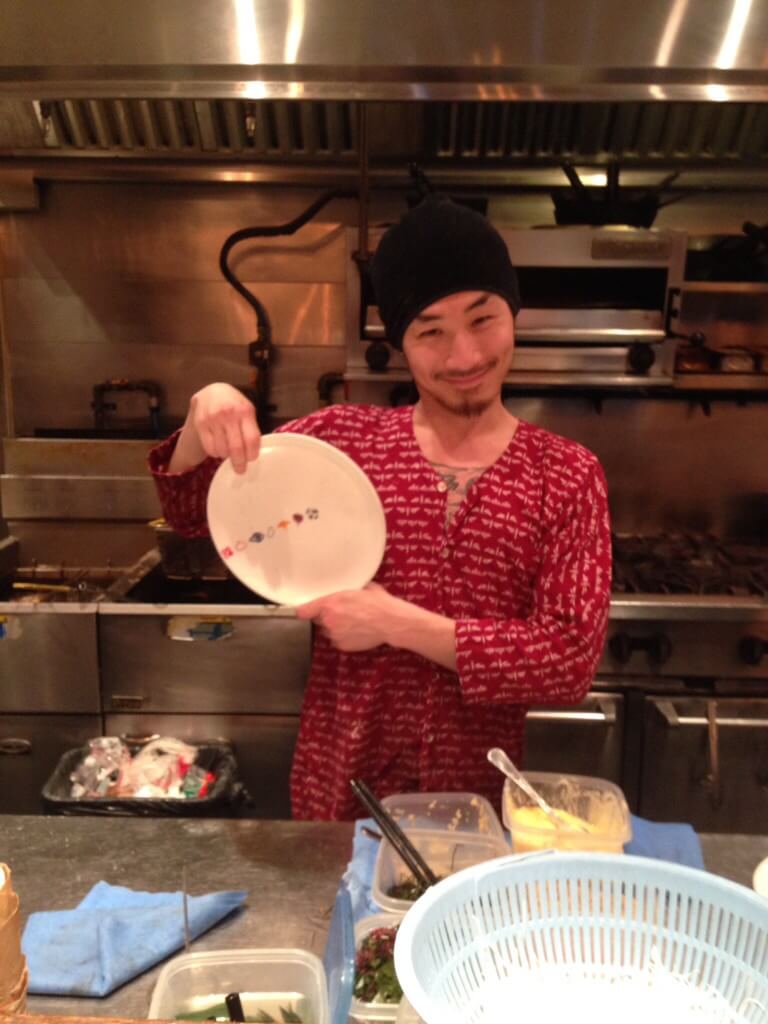 Photograph of chef holding plate